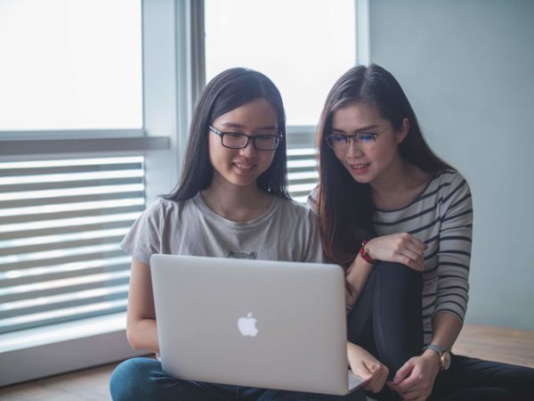 two people at a laptop