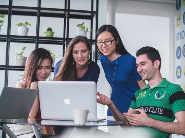 people around a laptop